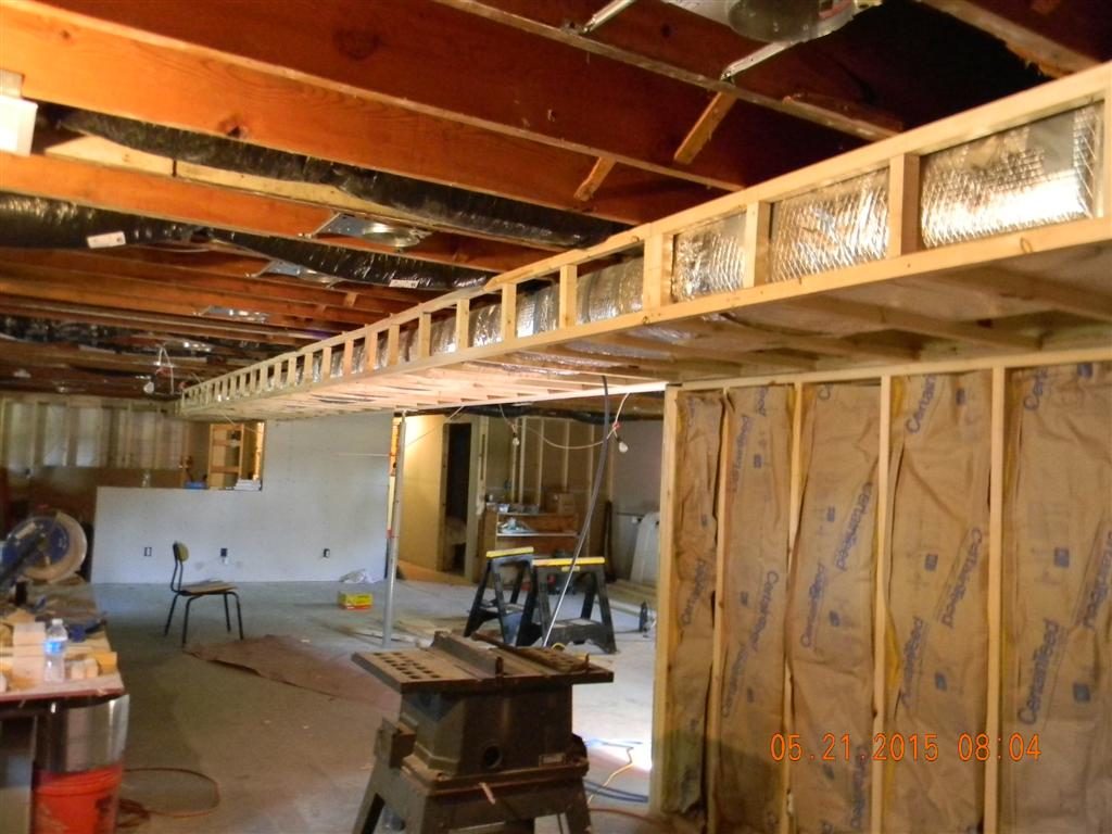 Installing a framework around the heat duct system so that dry wall could be attached.